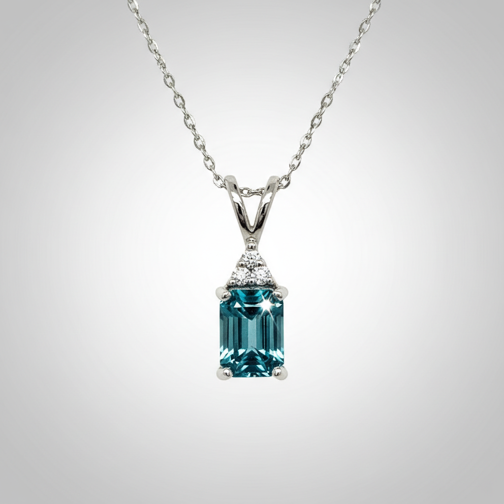 14K White Gold 1.25CT 5x7mm Emerald Cut Blue Zircon and 0.035 Carat Total Weight (3) Diamond Pendant