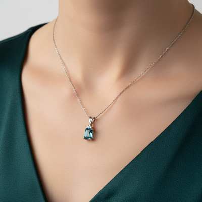 14K White Gold 1.25CT 5x7mm Emerald Cut Blue Zircon and 0.035 Carat Total Weight (3) Diamond Pendant