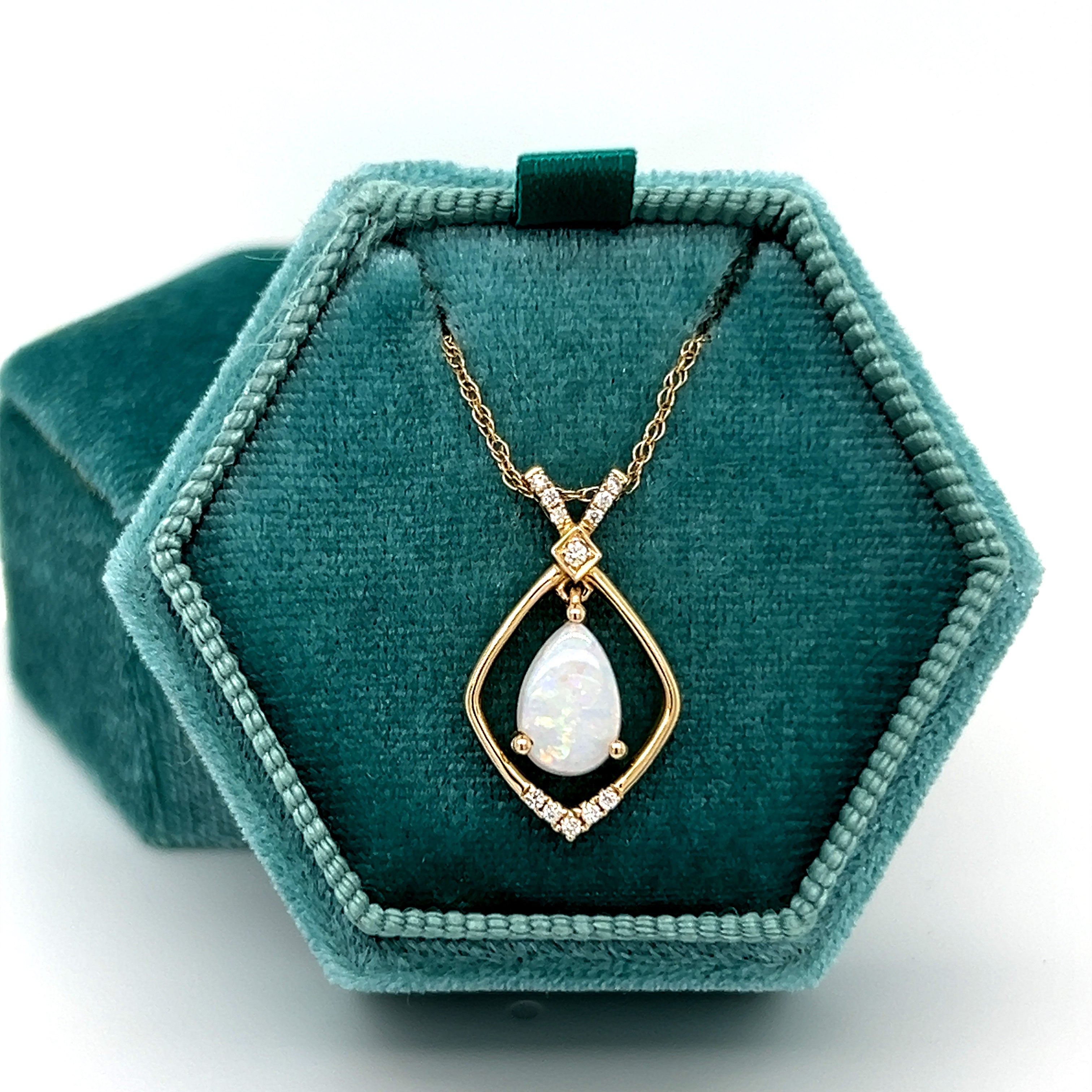 14K Yellow Gold 6x9mm 0.72CT Opal and 0.078 Carat Total Weight (12) Diamond Pendant