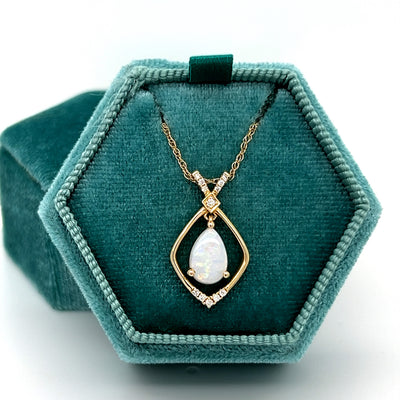 14K Yellow Gold 6x9mm 0.72CT Opal and 0.078 Carat Total Weight (12) Diamond Pendant