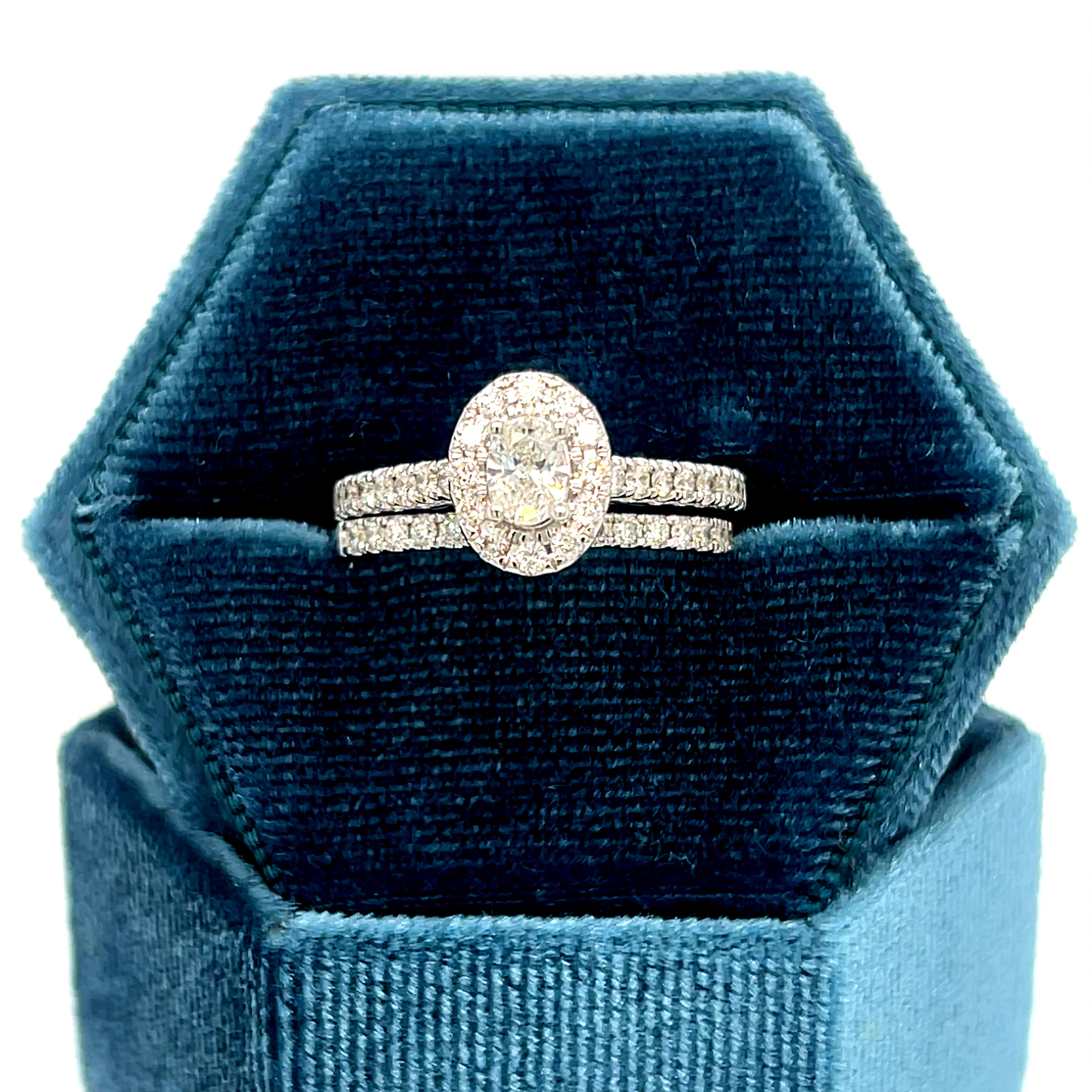 14K White Gold 1.00 Carat Total Weight Oval Halo Diamond Bridal Wedding Engagement Ring Set with .25CT 5x3mm Diamond Center and Peekaboo Diamond in the Gallery of Ring.