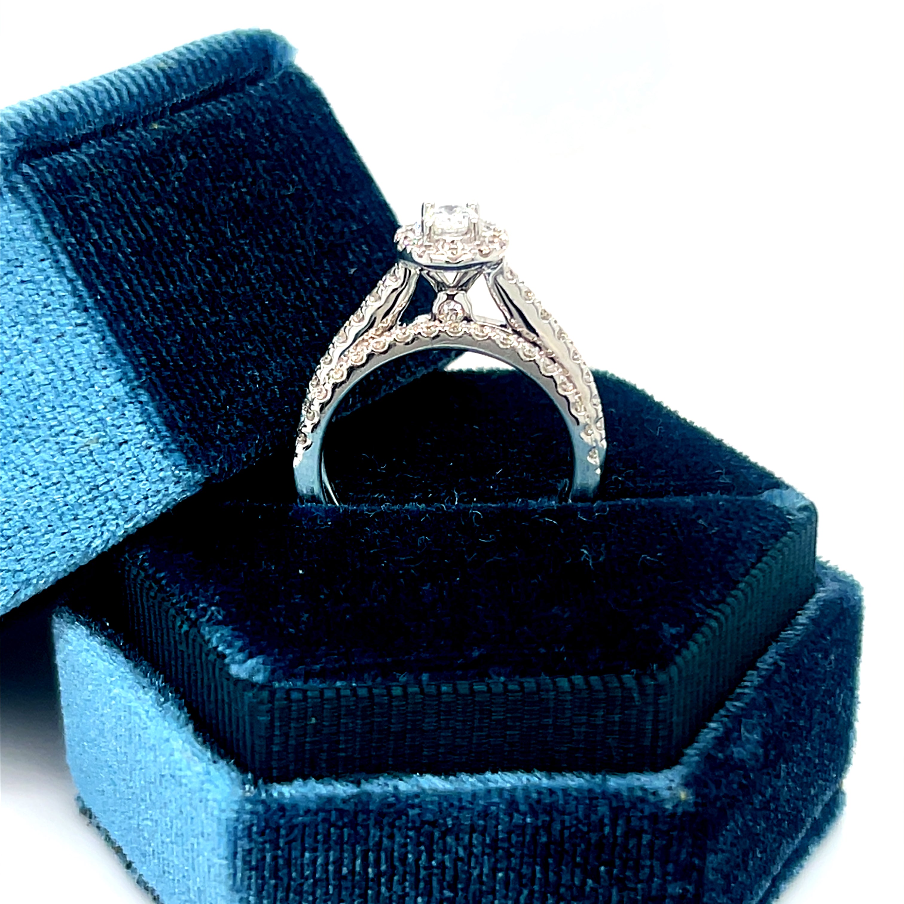 14K White Gold 1.00 Carat Total Weight Oval Halo Diamond Bridal Wedding Engagement Ring Set with .25CT 5x3mm Diamond Center and Peekaboo Diamond in the Gallery of Ring.