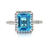 14K White Gold 7X9mm 2.73CT Emerald Cut Blue Topaz and 0.307 Carat Total Weight (42) Diamond Ring