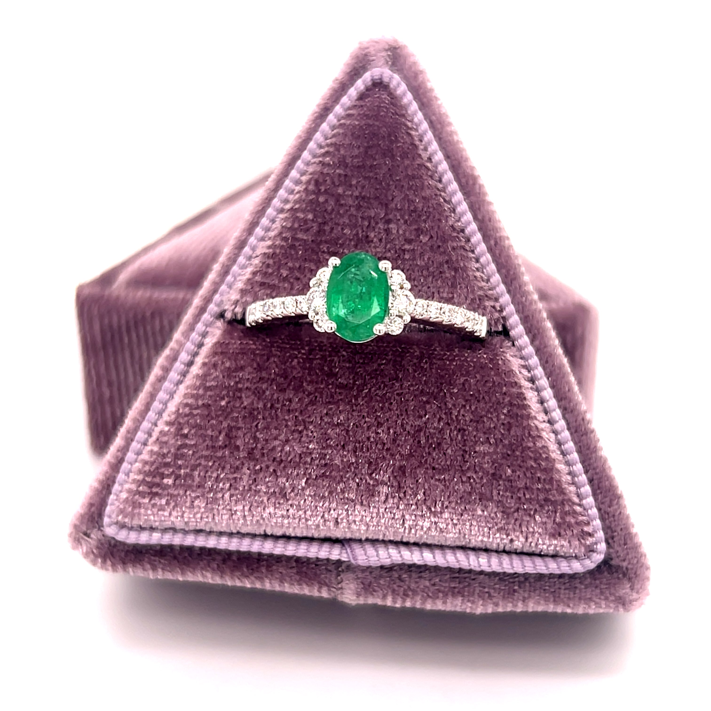 14K White Gold 0.69CT Oval Emerald and 0.24 Carat Total Weight (18) Round Diamond Ring