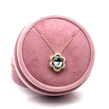 14K Yellow and White Gold 1.081CT Oval Aquamarine and 0.082 Carat Total Weight Flower Pattern Diamond Pendant