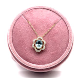 14K Yellow and White Gold 1.081CT Oval Aquamarine and 0.082 Carat Total Weight Flower Pattern Diamond Pendant