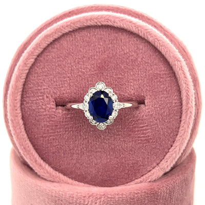 WJS Custom Set 14K White Gold 1.7 Carat Oval Lab Grown Blue Sapphire and 0.23 Carat Total Weight Lab Grown Diamond Ring with Floral/ Vintage Accents