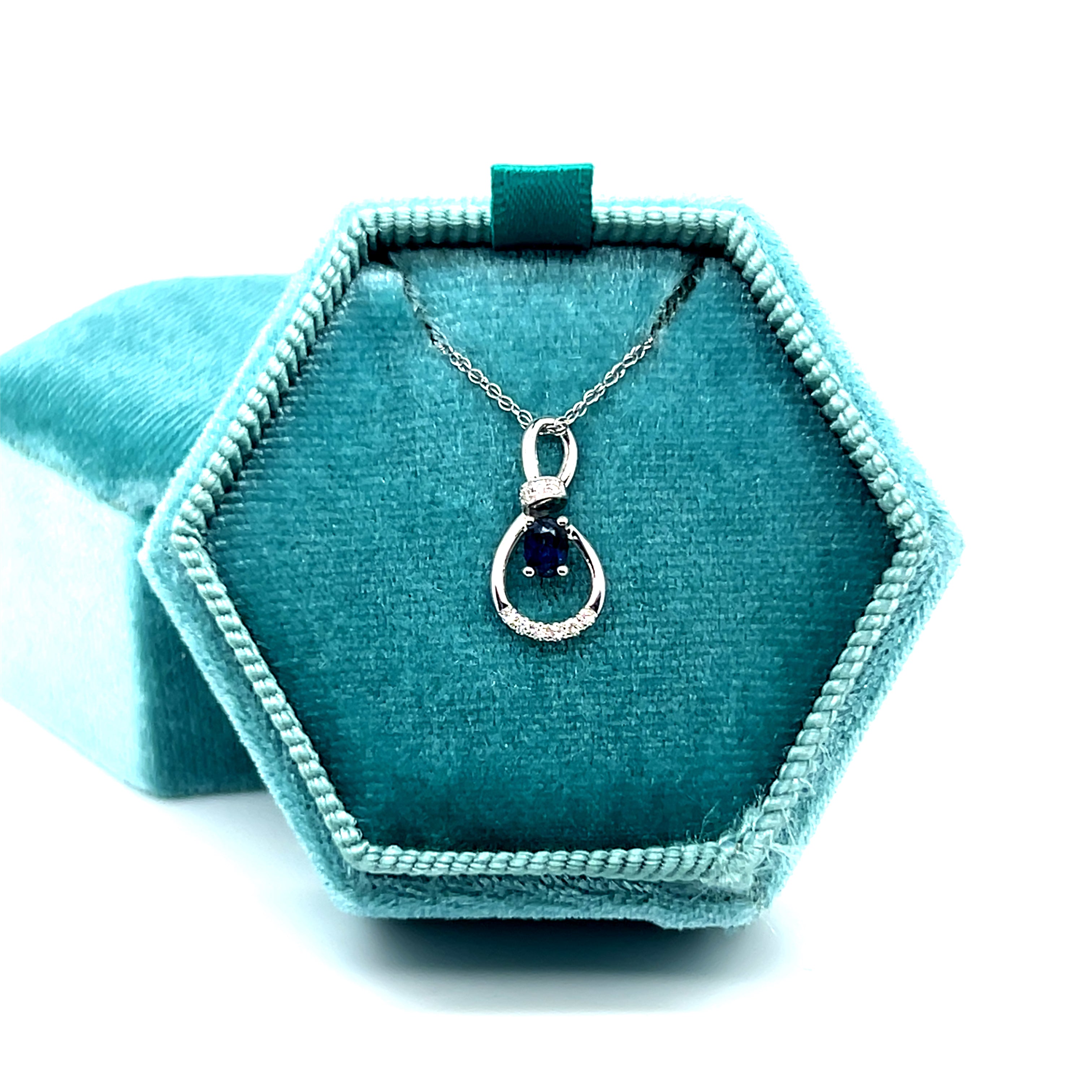 14K White Gold 0.19CT 3x4mm Oval Sapphire and 0.034 Carat Total Weight Diamond Infinity Style Pendant