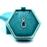 14K White Gold 0.19CT 3x4mm Oval Sapphire and 0.034 Carat Total Weight Diamond Infinity Style Pendant