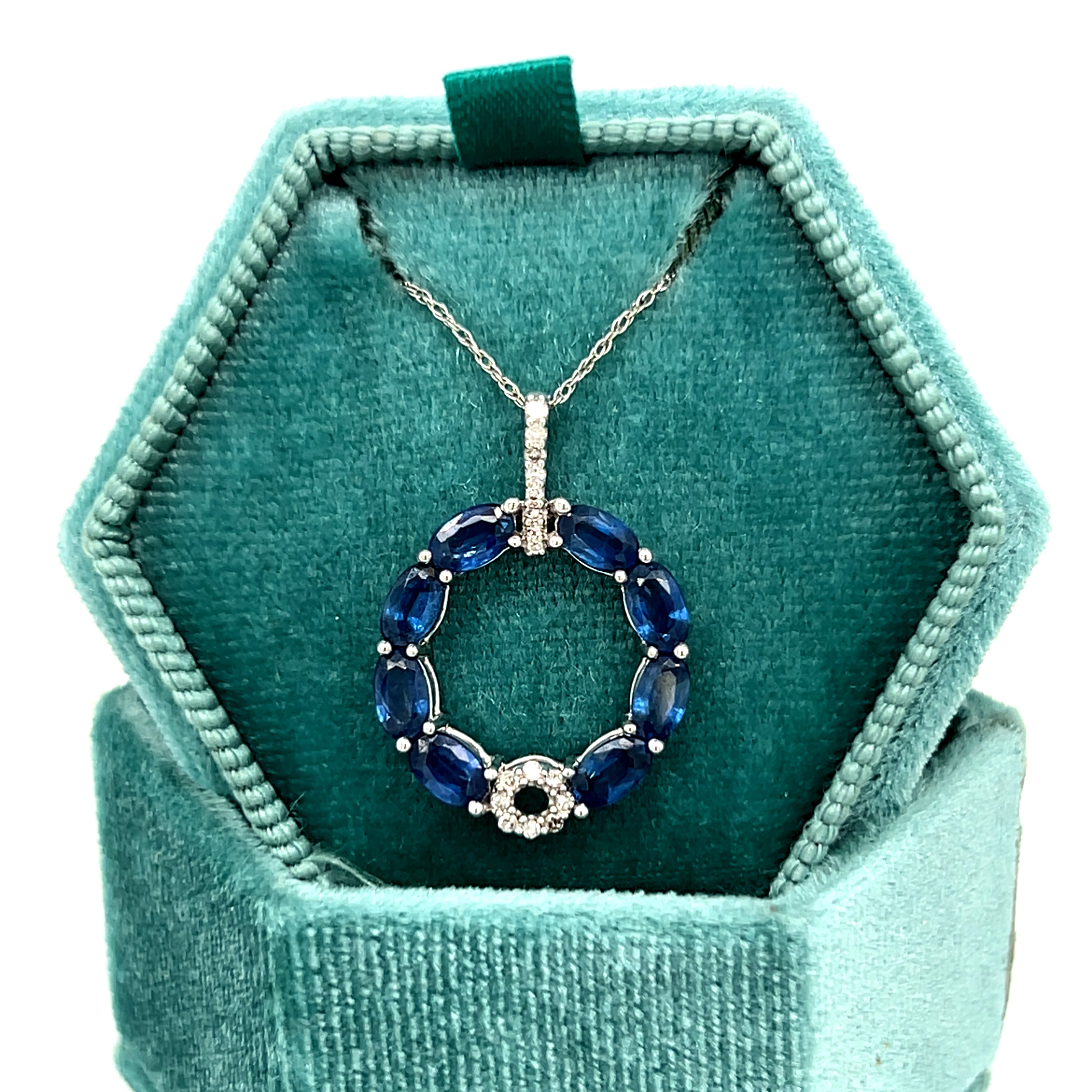 14K White Gold 2.50 Carat Total Weight (8) Oval Blue Sapphire Accented by 0.12 Carat Total Weight Natural Diamond Circle Pendant