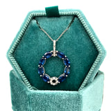 14K White Gold 2.50 Carat Total Weight (8) Oval Blue Sapphire Accented by 0.12 Carat Total Weight Natural Diamond Circle Pendant