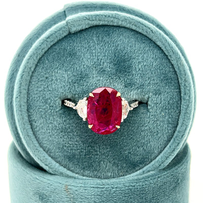 White and Yellow Gold Oval Ruby with Step Cut Shield Diamonds and Round Diamond Ring